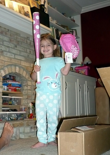 Alana shows off her pink bat and glove (courtesy of her dad)