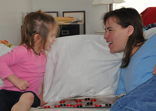 Alana and Julie in a fierce game of checkers