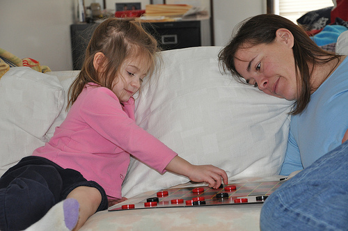 Alana and Julie in a fierce game of checkers