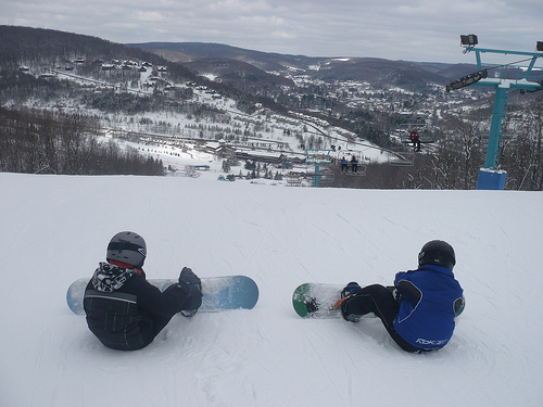 Carson and Benton strapping into their snowboards