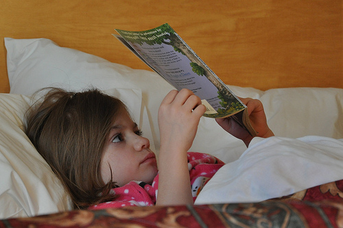 Alana reads in bed at the hotel